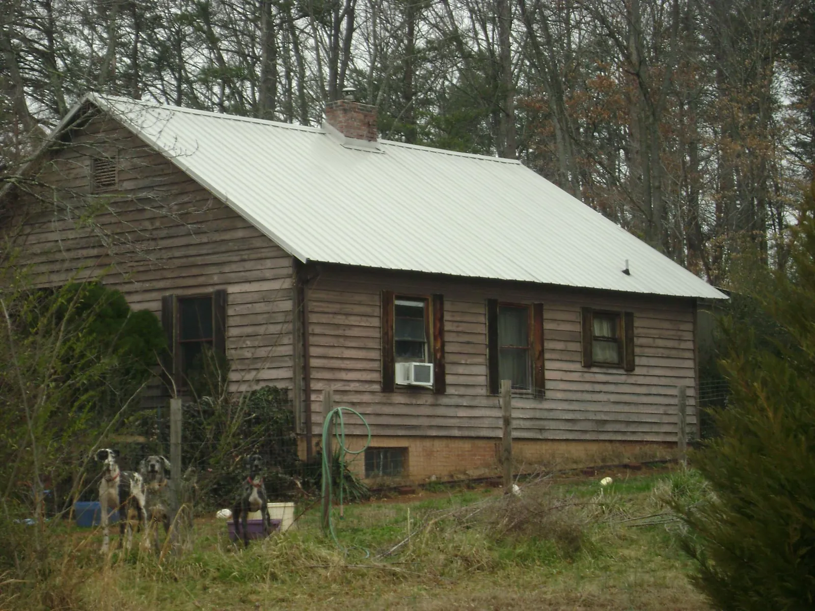 White metal roof on an old wood sided farmhouse, from a Metal Roof Installation job in Georges Mills